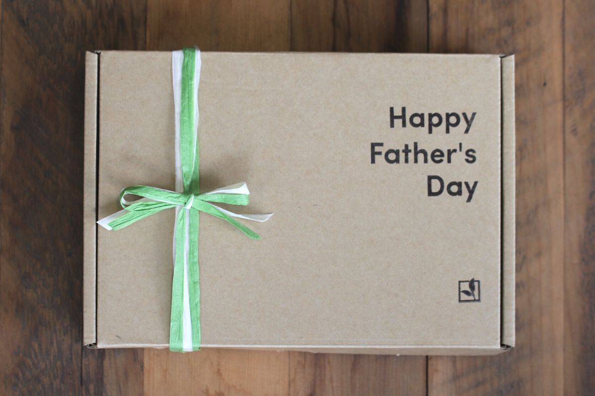A Kraft gift box stamped with 'Happy Fathers Day' on it